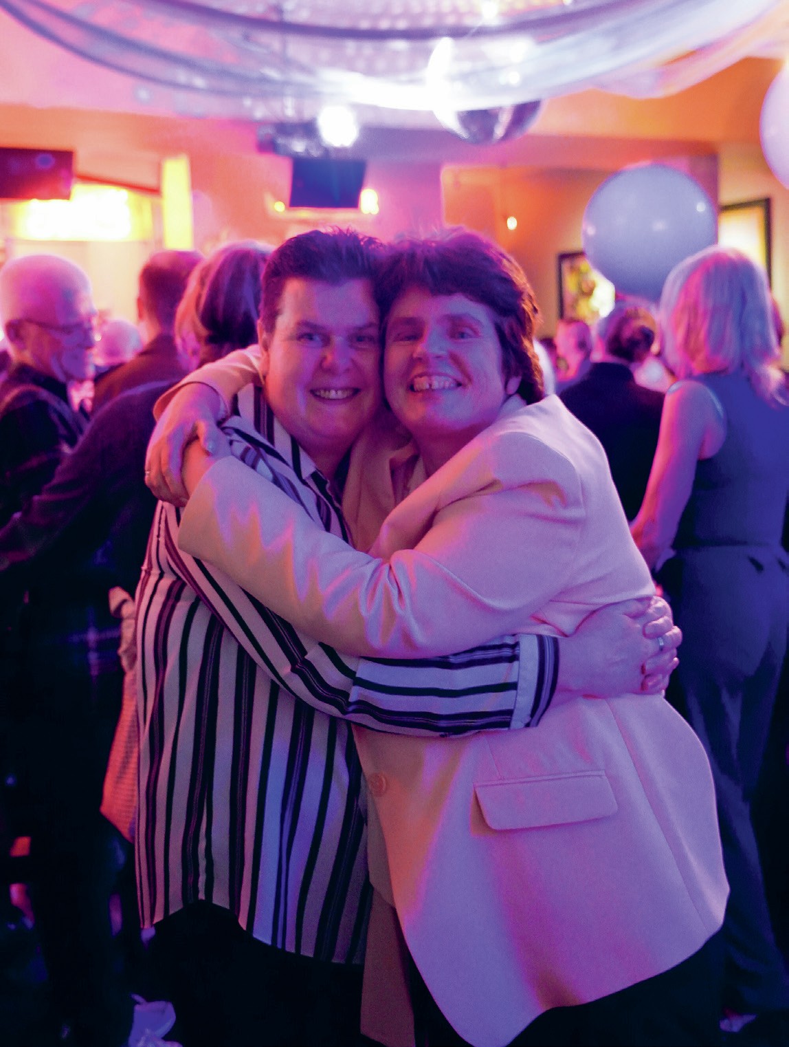 Two women hugging at Dublin's LGBTQ+ prom